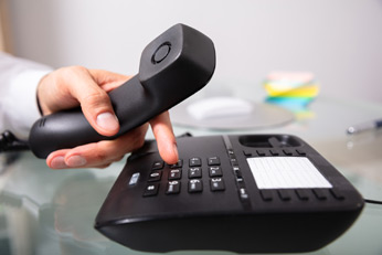 Compare business phone systems hand dialing phone.