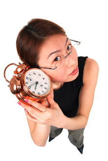 Girl with clock by ear.