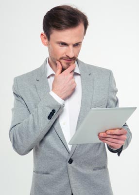 Business owner reading about VoIP benefits.